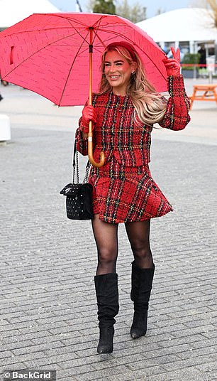 Check her out! A glamorous guest showcases her chic tartan outfit at the racecourse