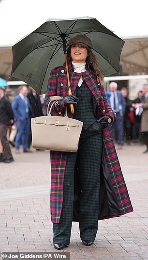 Another glamorous racegoer dons a fashionable tartan overcoat