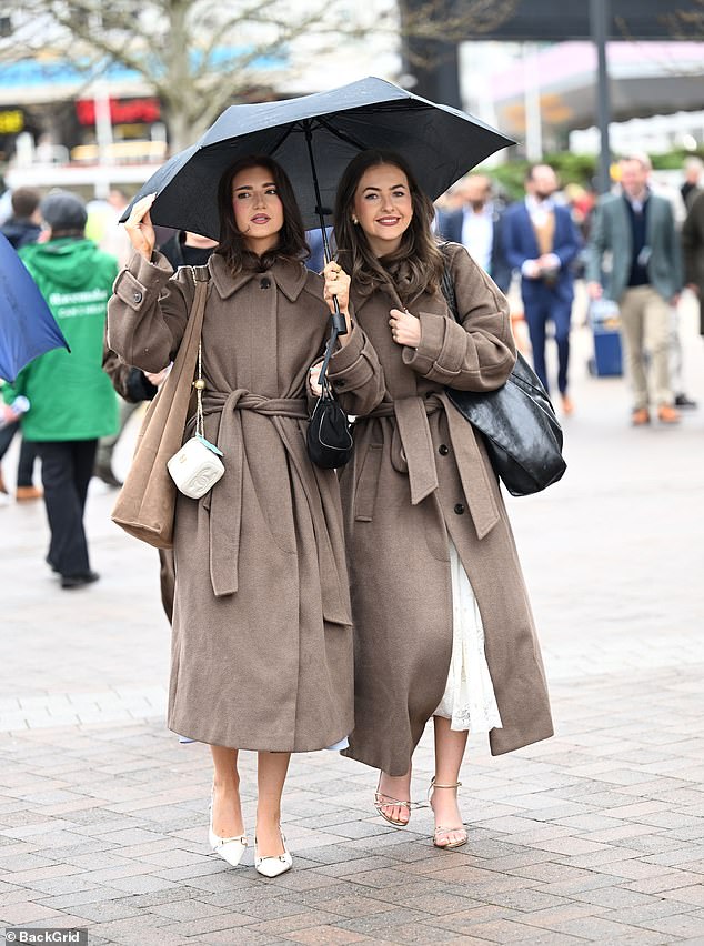 Matching: An elegant pair of racegoers showcase similar looks as they attend the festival