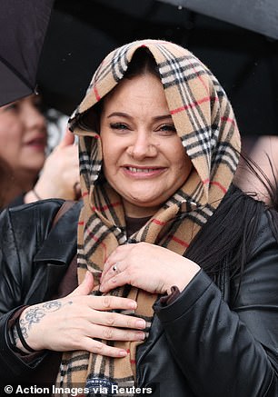 This reveller protected herself from the rain with a brown and red check scarf around her head