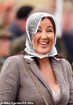 Making the most of it: This racegoer refused to let the wet weather ruin her cheer