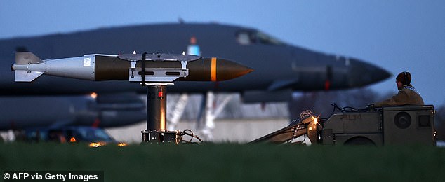 USAF military ground personnel load Joint Direct Attack Munitions (JDAM) into a US Air Force (USAF) B-1 Lancer bomber on the tarmac at RAF Fairford in south-west England on March 11