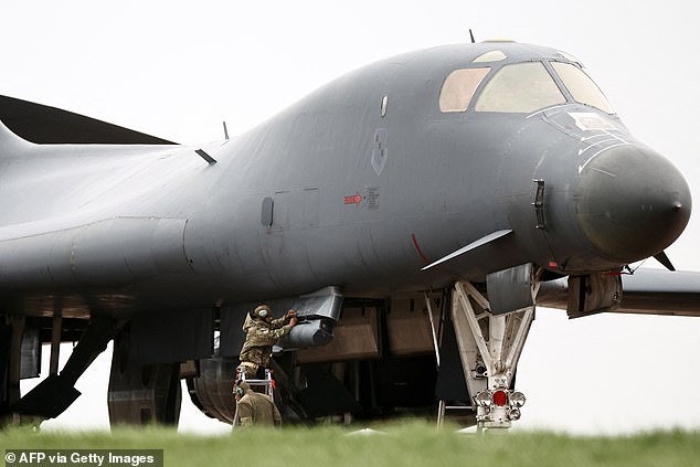 Personnel work on a US Air Force B-1 Lancer bomber parked on the tarmac at RAF Fairford in south-west England on March 12