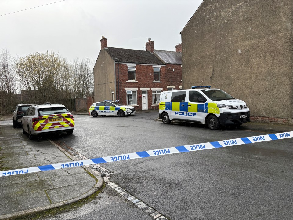 Police cordon in Shildon, County Durham, with police vehicles on the street.