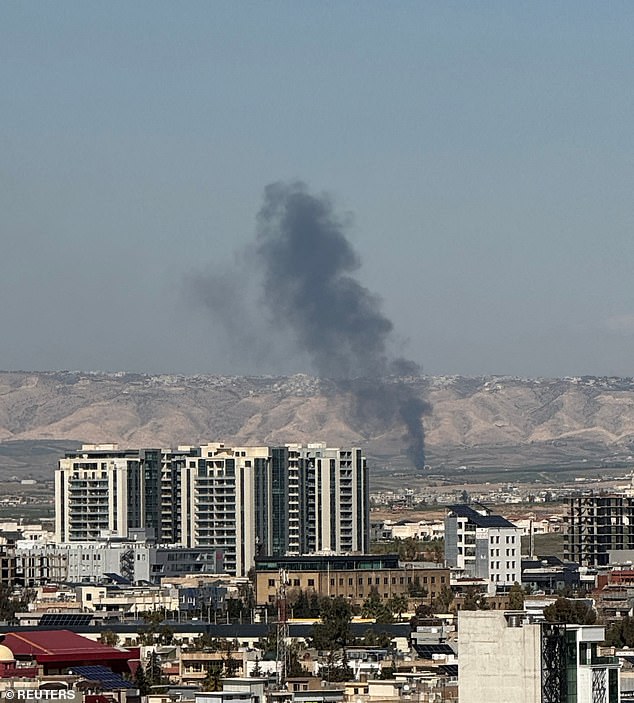 Smoke rises from the site of a drone crash on the outskirts of Erbil, Iraq