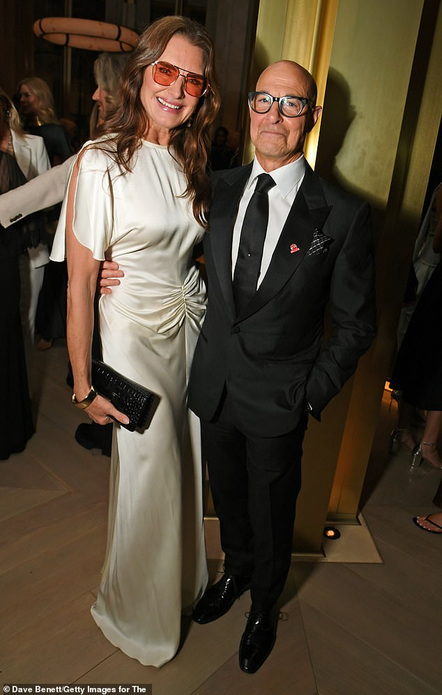 Stanley Tucci looked rather dapper in a black suit, white shirt and tie