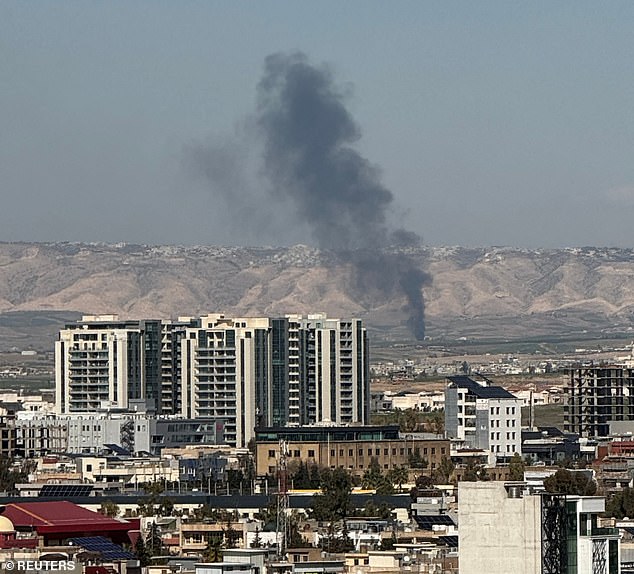 Smoke rises from the site of a drone crash on the outskirts of Erbil, Iraq on Thursday