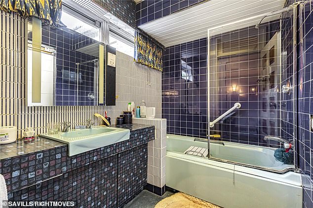 One of the ensuites attached to a bedroom contains period piece pale mint sink and bathtub