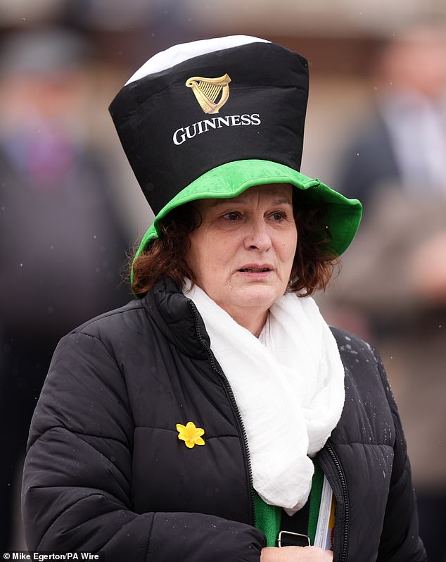 A racegoer in a Guinness hat on day three of the Cheltenham Festival in Gloucestershire