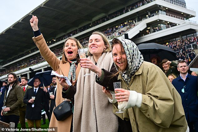 These racegoers refused to let the wet weather ruin their cheerful spirits
