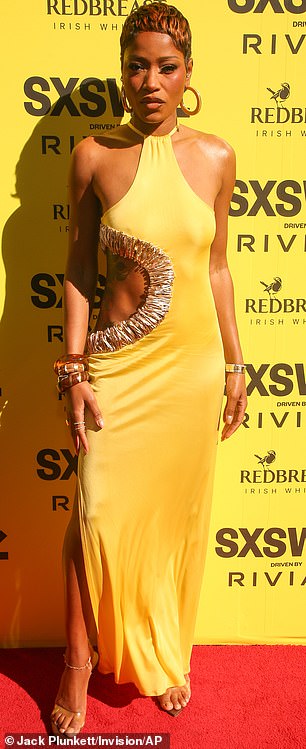 The 32-year-old's halter neck canary yellow frock was perfectly cut to emphasize her toned physique and featured a thigh-slit up the right side
