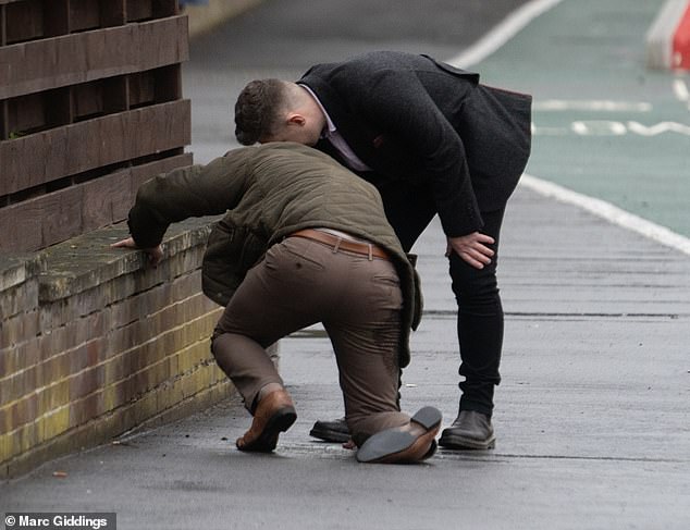 Some racegoers were seen looking worse for wear yesterday as they left Cheltenham Festival yesterday (Pictured: A men dressed in brown kneels on the floor)