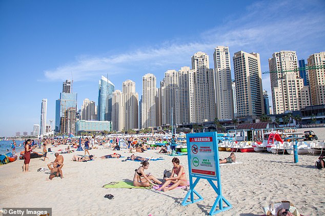 The white sand Jumeirah Beach (pictured before the war) is a favourite among Dubai's 240,000 British expats