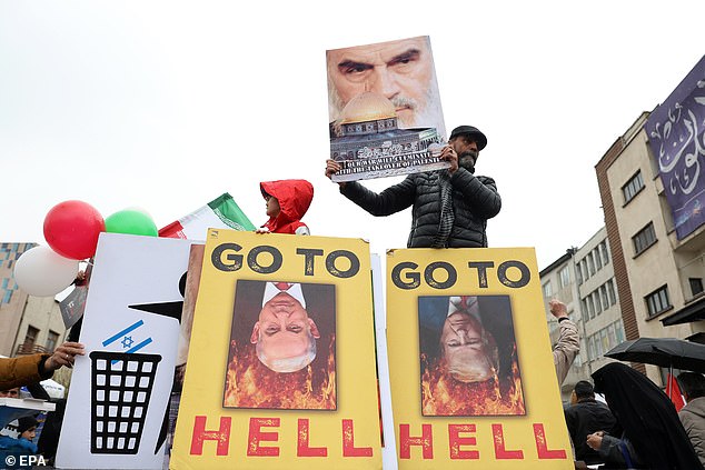Iranians hold placards against Trump and Netanyahu during a rally in Tehran, Iran on March 13