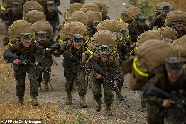United States Marine Corps (USMC) recruits from Lima Company, the first gender integrated training class in San Diego complete their 9.7 mile hike on Edson Range to the top of a mountain called The Reaper, during The Crucible, the final part of phase three of recruit training before officially becoming US Marines on April 22, 2021 at Camp Pendleton in San Diego County, California