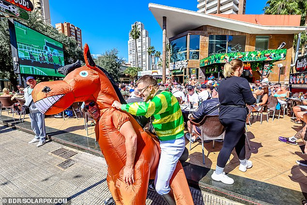 A pair punters dressed up as a horse and a jockey in Benidorm. Brits have flocked to the Costa Blanca to watch the races in recent years with hotel bookings rising by a staggering 225 per cent