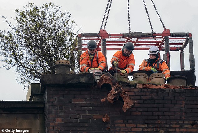Three workers began work knocking down the ruins of the landmark Union Corner building in Glasgow