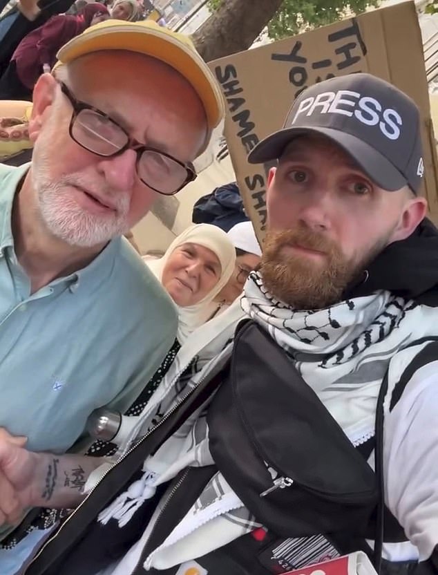 Pictured: Mr Bourne, right, wearing a fake press hat, at a rally with former Labour leader Jeremy Corbyn, left