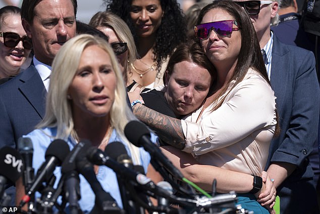 Jena-Lisa Jones, centre, hugs Haley Robson, right, as Rep. Marjorie Taylor Greene, R-Ga., left, speaks during a news conference at the U.S. Capitol, Wednesday, Sept. 3, 2025, in Washington