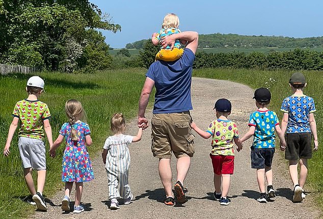 Oliver walks with seven of his children. Today the Jackson brood ranges in age from 19 to three