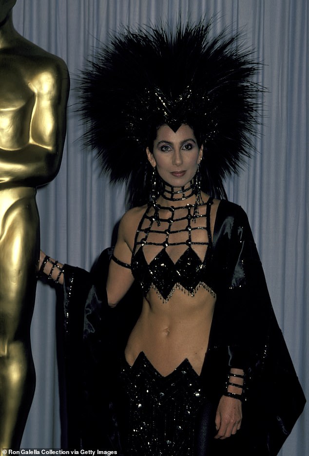 In 1986, singer Cher stepped out at the event in a belly-baring skimpy sequin ensemble, complete with a huge feather headdress