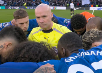 Referee Paul Tierney awkwardly gets caught right in the middle of Chelsea huddle before Newcastle clash
