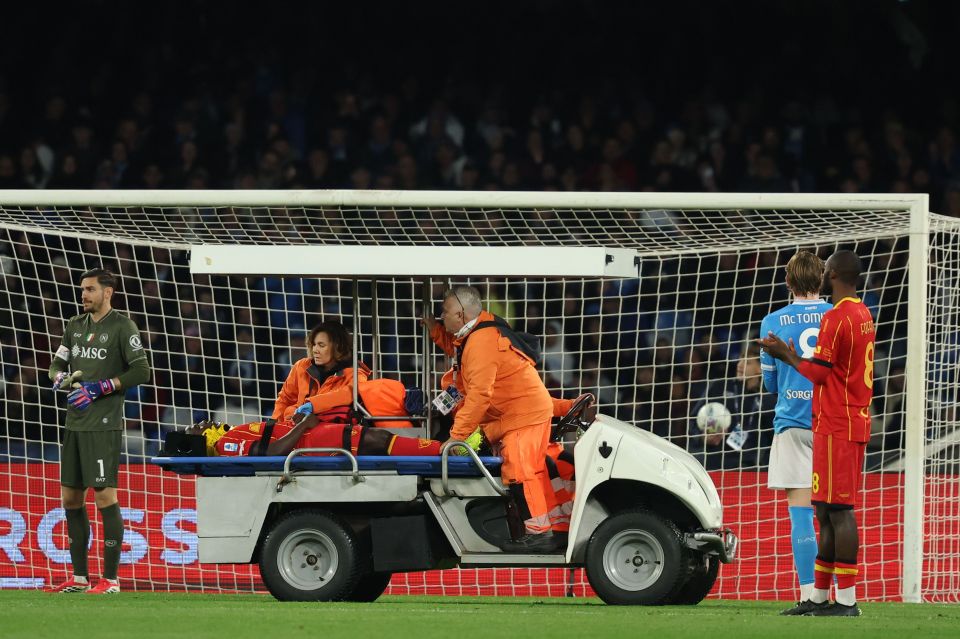 Lecce's Lameck Banda is carried off the field on a stretcher by medical staff during a soccer match against Napoli.