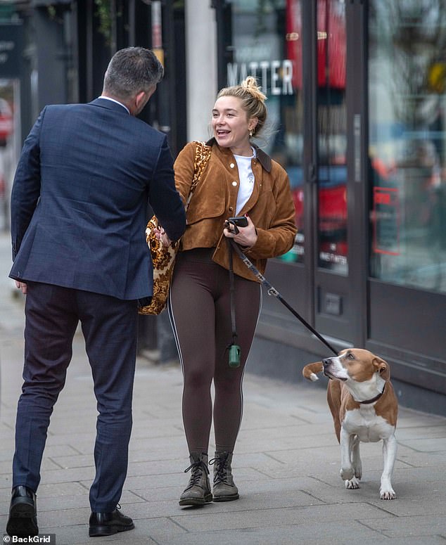 Billie watched on as his famous owner shook hands with a man on the street