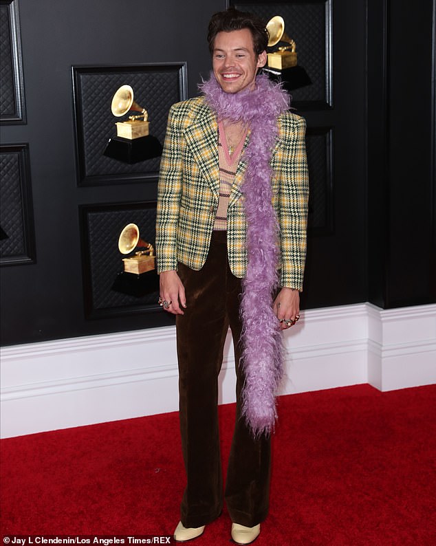 Earlier in 2021, he attended the red carpet of the Grammys in this striking ensemble that included a purple feather boa and a plunging v-neck