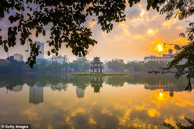 Sunrise over Hoan Kiem Lake where dawn tai chi sessions unfold in humid-but-bearable warmth
