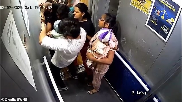 The residents of the building lept into action, totally shocked by the sudden emergency. They managed to get the baby's arm out of the door after a tense two minute struggle