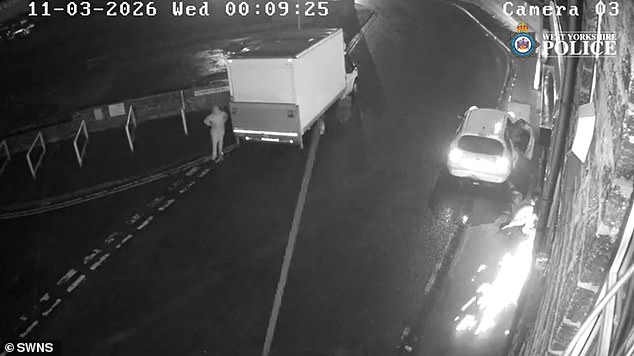 A person can be seen cutting into the metal shutters of the shop with a circular saw, causing sparks to fly