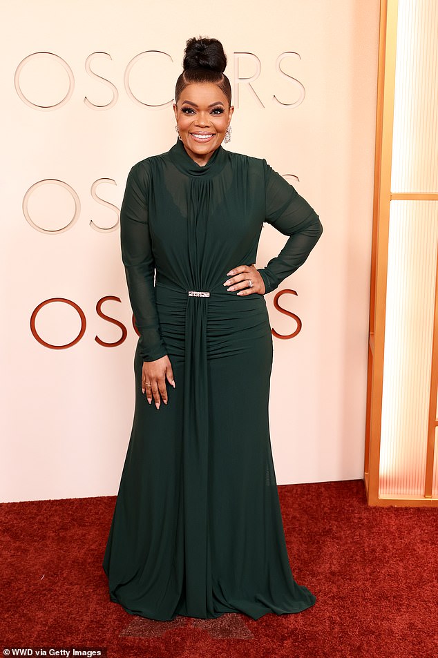 Yvette Nicole Brown, 54, exuded Hollywood glamour in a flowing, forest green gown paired with a chic topknot hairstyle