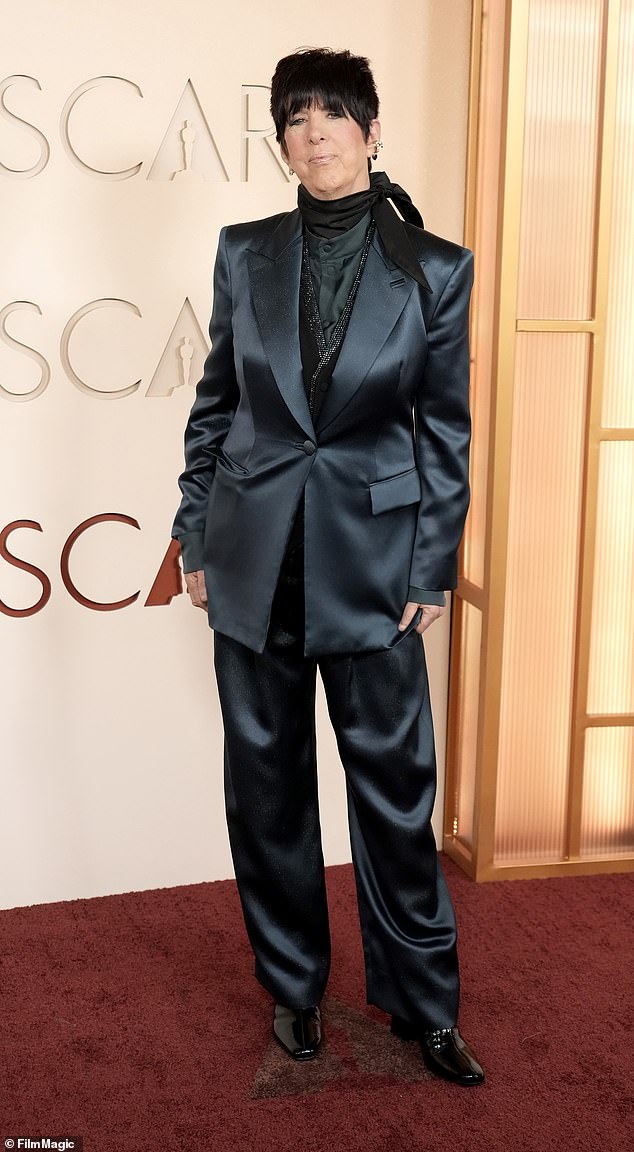 Business casual? Diane Warren looked like she was heading into the office rather than the Oscars, as she donned a dark, navy blue silk suit with a bejeweled black turtleneck underneath. She wrapped the look together with patent leather black boots