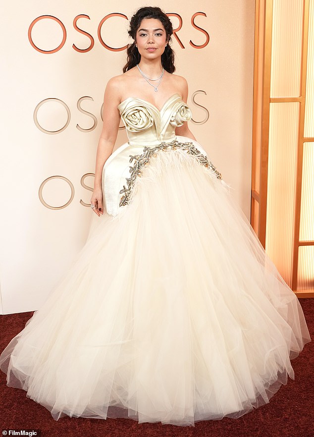 Way too over the top! Actress Auli'i Cravalho looked like she was going to the Met Gala rather than the Oscars, as she donned a strapless, cream-colored gown with a huge skirt made of tulle. The top featured two oversized, sculptural roses as the bust, as she tied her look together with two diamond necklaces