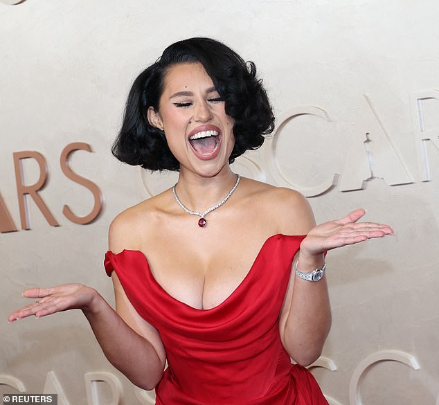 The hitmaker showed off her famous curves in a form-fitting red satin gown