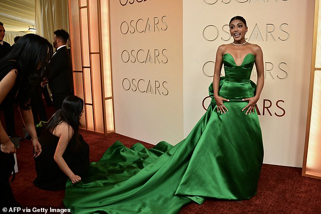 Bridgerton star Charithra Chandran cut a glamorous figure in a dramatic green satin gown as she arrived on the red carpet