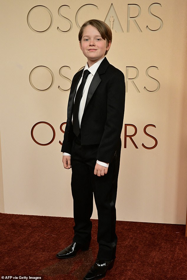 Hamnet star Jacobi Jupe was dressed in a sharp black suit after earning for his role as William Shakespeare's son in the drama