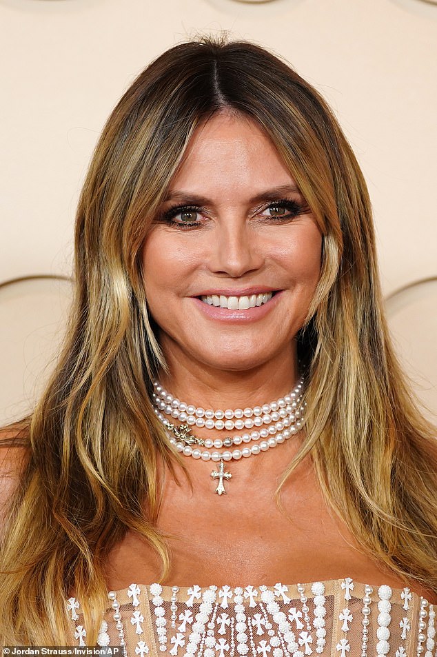 With her long blonde hair worn down with bushy bangs, the 52-year-old cover girl looked every inch a pinup. There was also a religious theme with crosses on her dress and one on her necklace