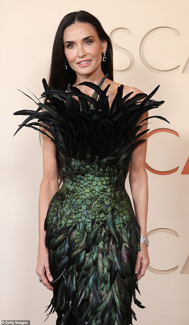 The actress, 63, arrived at the Academy Awards red carpet on Sunday wearing a strapless black and green Gucci gown that certainly ensured all eyes would be on her