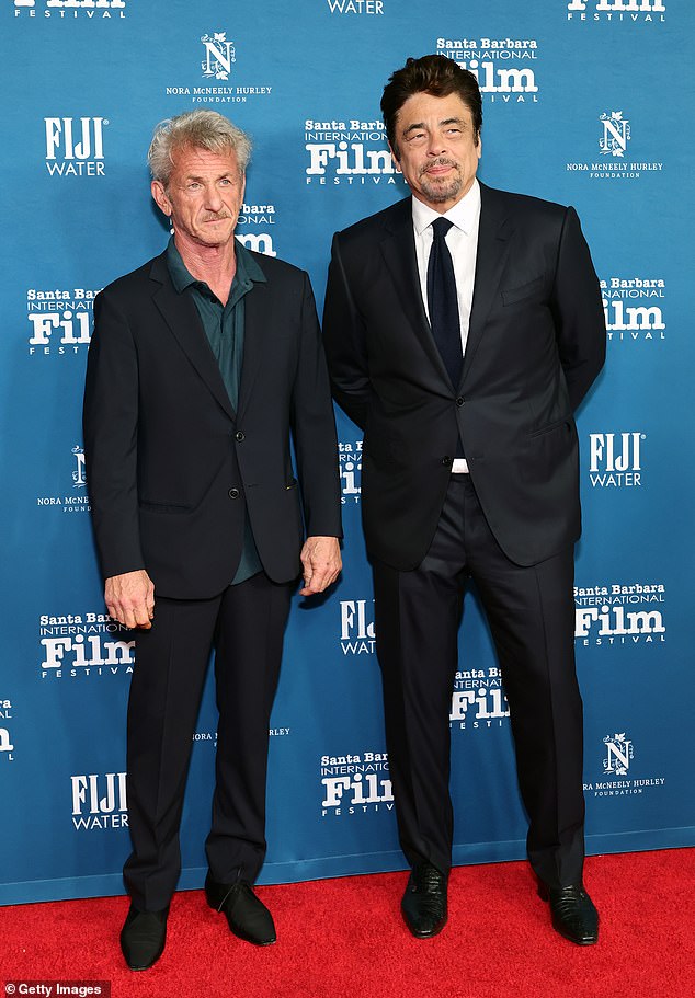 The 65-year-old A-lister's name was announced by Kieran Culkin for the Best Supporting Actor Award for his work in One Battle After Another but he was not in the building (Penn is pictured with co-star and fellow nominee Benicio del Toro in Santa Barbara last month)
