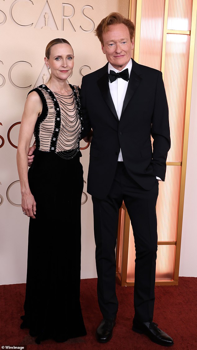 Liza, 55, ensured all eyes would be on her as she arrived at the event arm-in-arm with O’Brien, 62, wearing a dramatic outfit that contained a sheer top covered in studs and chains