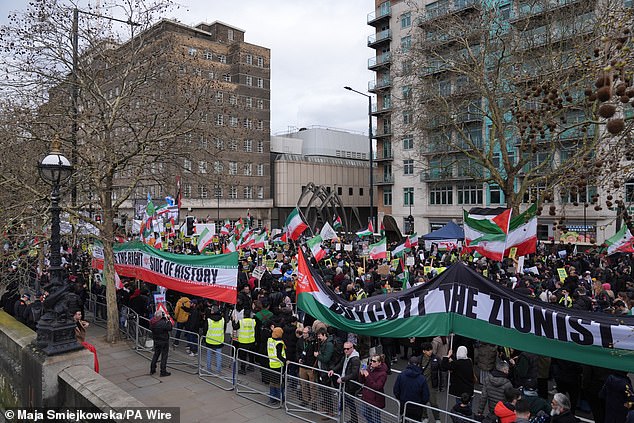 Pro-Iran demonstrators unfurl huge Palestinian flags brandished with the words 'boycott the Zionist' and 'Be on the right side of history'