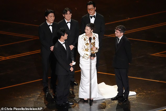 Singer EJAE, 34, proudly took the stage to accept the prize, which she shared with her co-writers Ido, Yu Han Lee, Hee Dong Nam, Mark Sonnenblick, Teddy and 24