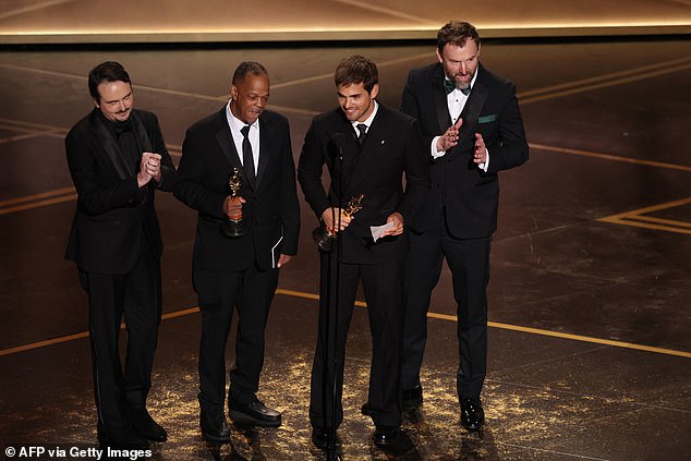 The award was split between the creators of the short films The Singers and Two People Exchanging Saliva; (From left) David Breschel, Mike Yung, Sam Davis and Jack Piatt accepting the gong for The Singers
