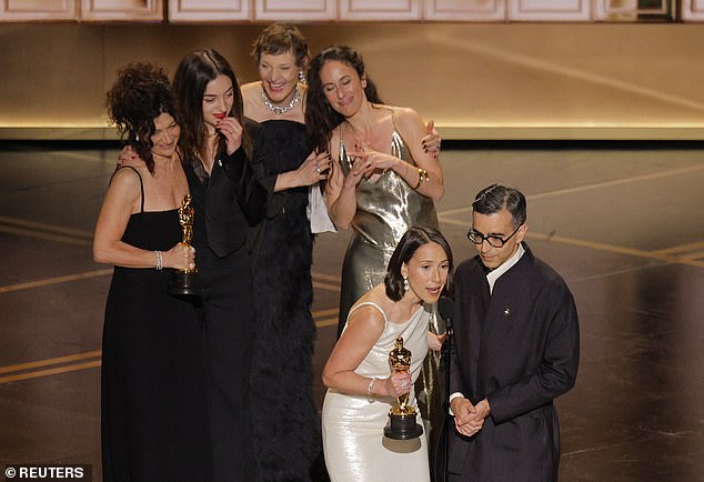 Nanjiani revealed that he would announce only one film at a time to preserve the surprise for the second group of winners. Directors Natalie Musteata (front left) and Alexandre Singh (front right) accept for Two People Exchanging Saliva