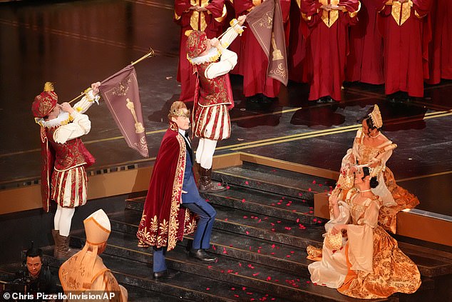 The bizarre stunt saw O'Brien waltzing down the aisles in the Dolby Theatre as two men placed a crown on his head and a King's robe around him