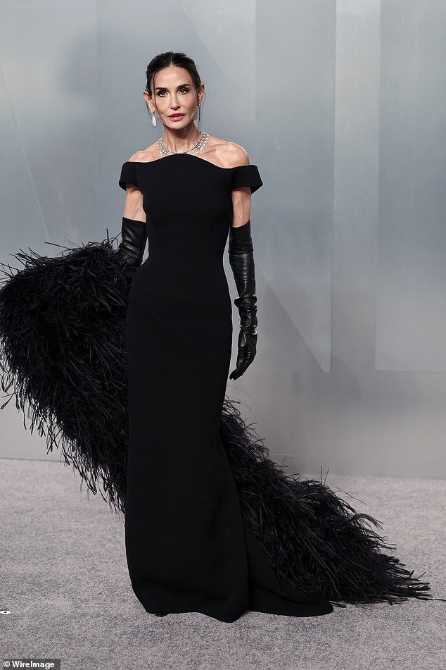 Demi Moore turned heads in a glam black gown with feathered shawl