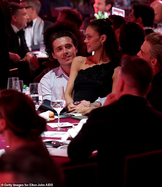 The couple - known for their fawning displays of affection - were draped across each other during the bash