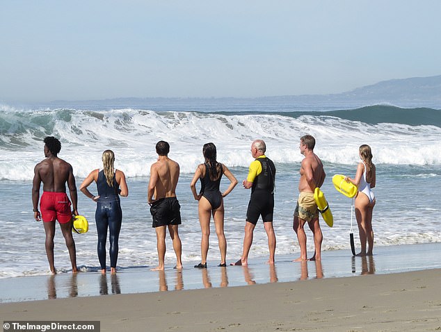 The stars were later spotted at the shoreline with various castmates holding yellow lifeguard floats